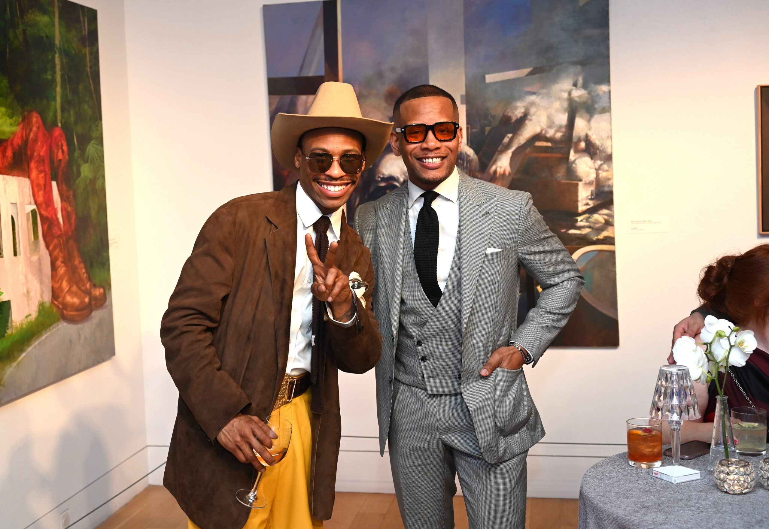 2 men in suits posing for photograph