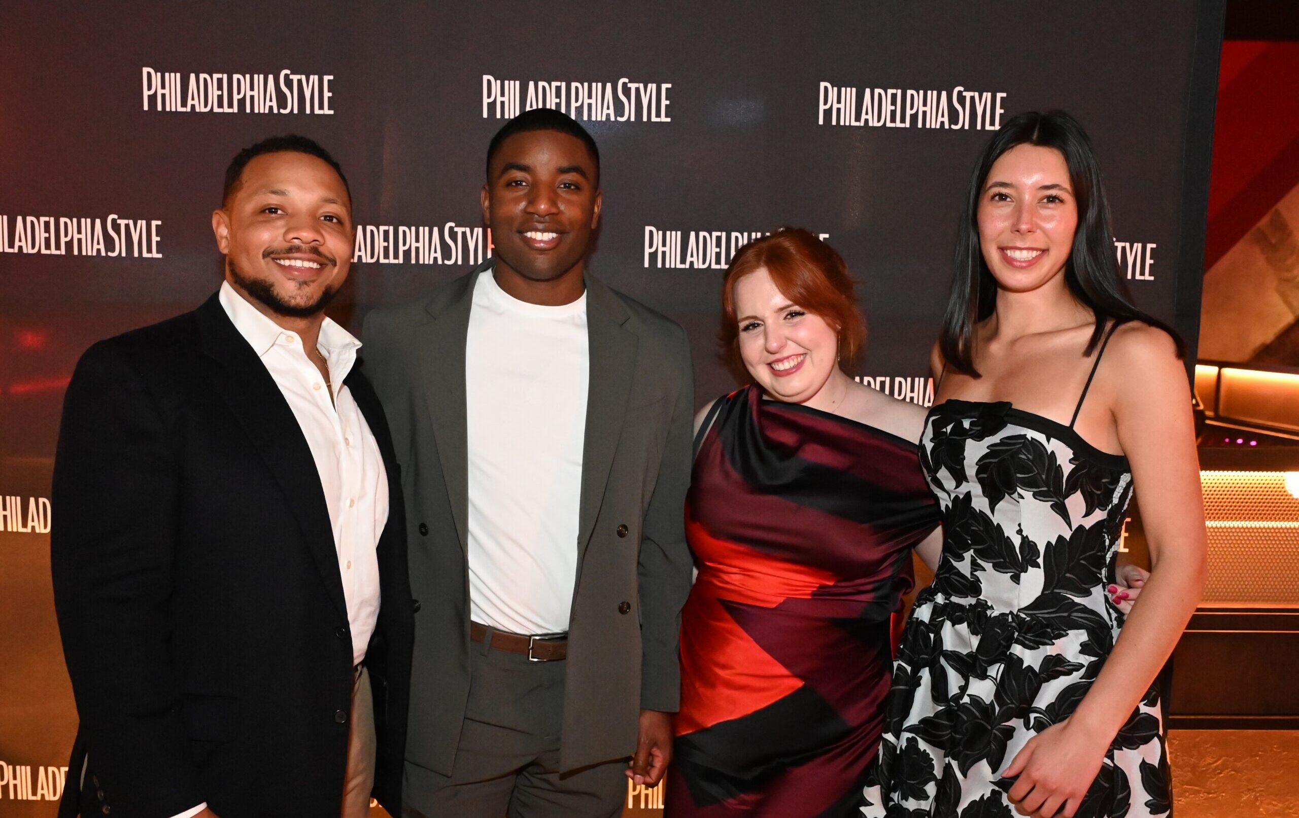4 people posing in front of Philadelphia Style step & repeat