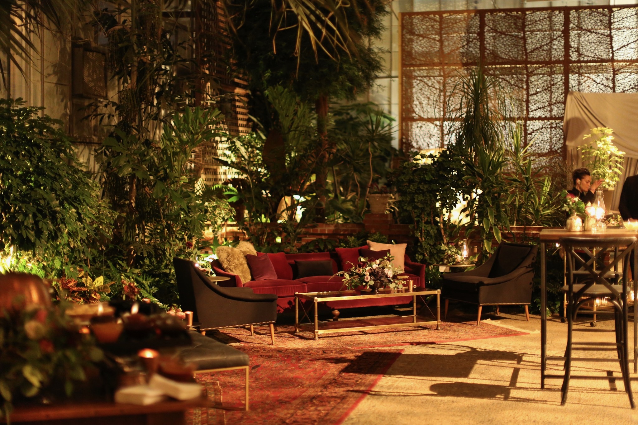 red couch and lounge area among greenery