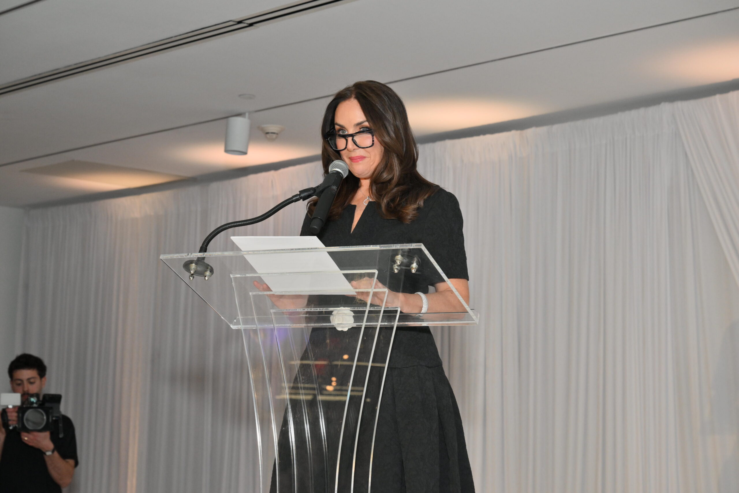 Nicole Cashman speaking at podium