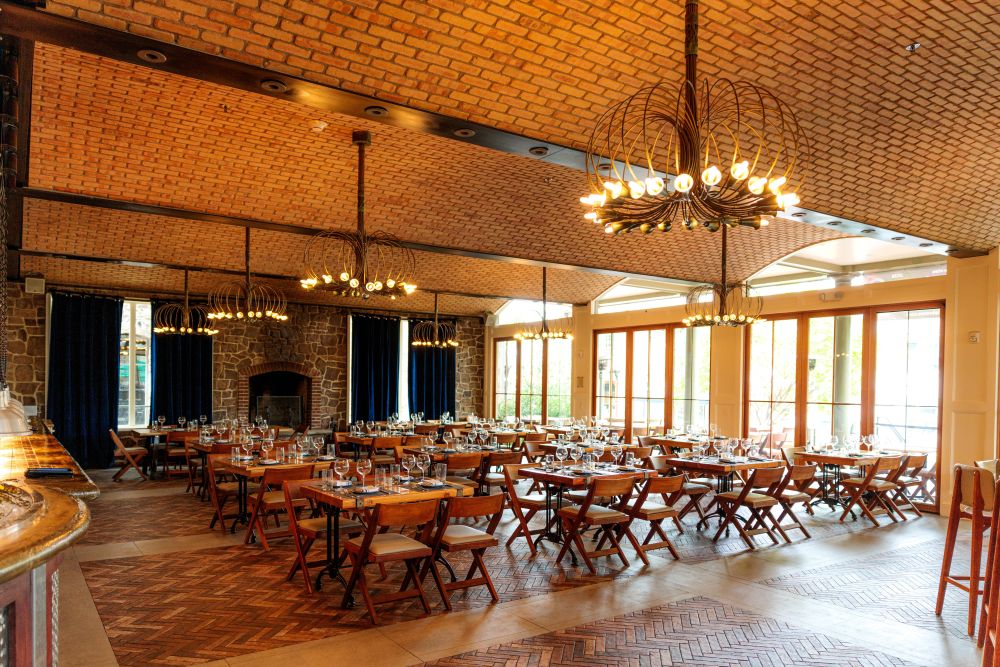 exposed brick room lined with banquet tables