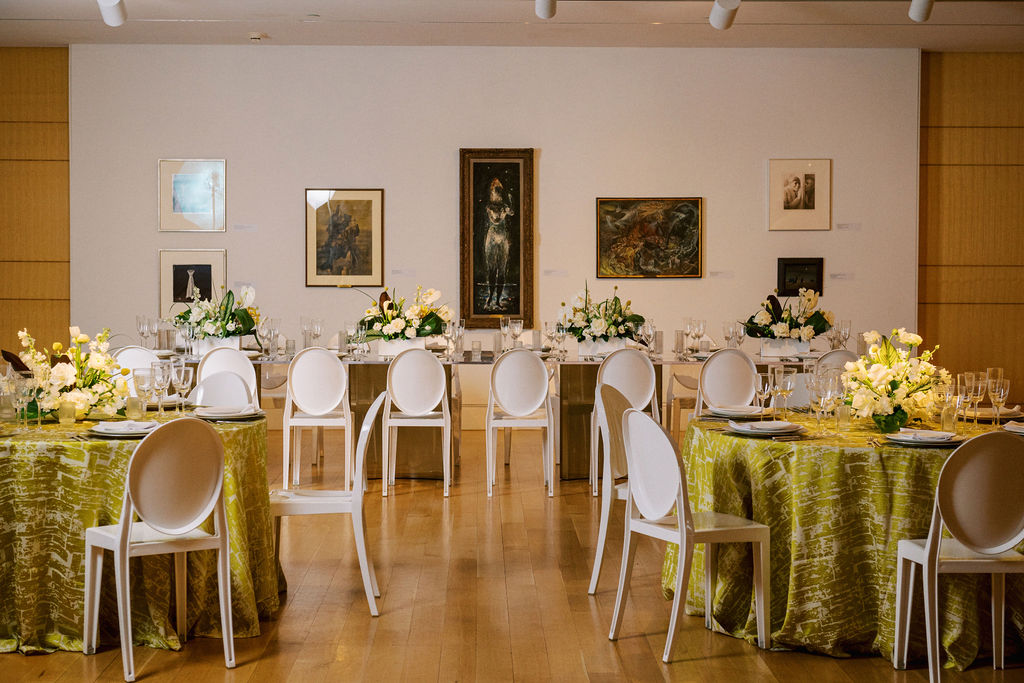 museum gallery set for a private event with banquet tables 