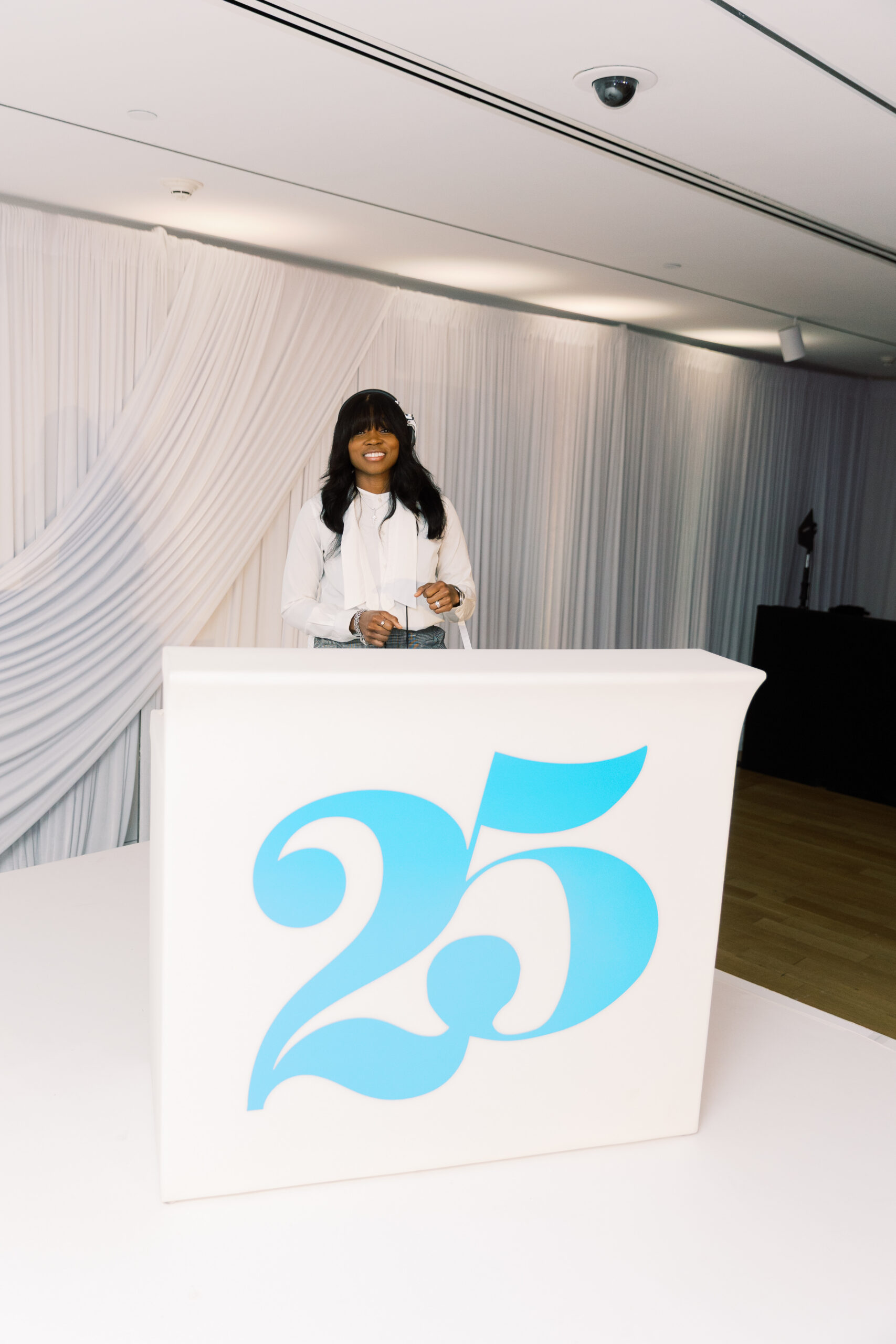 DJ Diamond Kuts behind the 25th Anniversary branded DJ booth