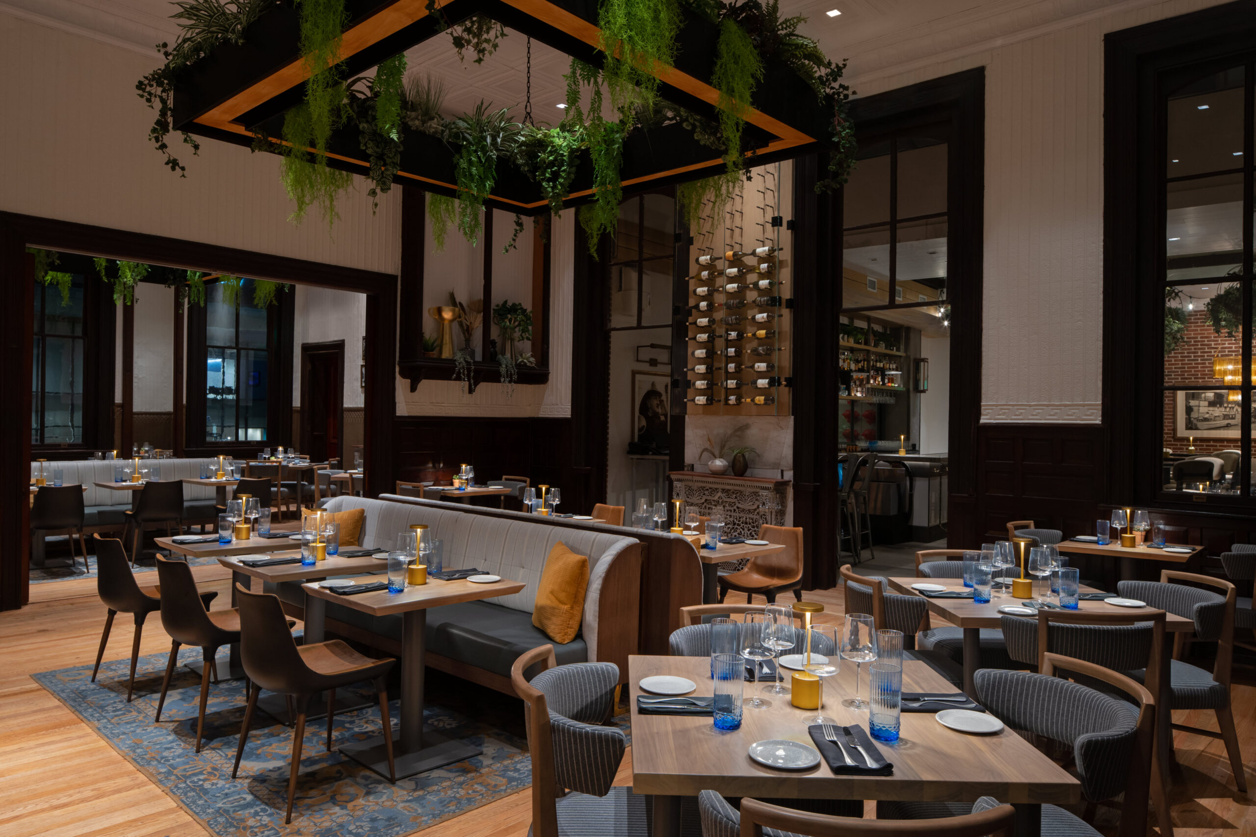 intimate dining area with greenery decor above